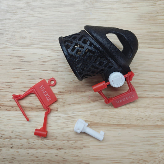 Black and red plastic components on a wooden surface
